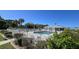 Community pool with clear blue water, ample seating, and a fully fenced perimeter for safety and relaxation at 3300 Loveland Blvd # 3303, Punta Gorda, FL 33980