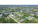 Aerial view showcasing the property in a waterfront community with lush landscaping and canal access at 4363 Sansedro St, Port Charlotte, FL 33948