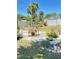 Outdoor patio area with a table set, surrounded by lush greenery and a storage shed, providing a tranquil space at 4363 Sansedro St, Port Charlotte, FL 33948