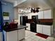 Well-appointed kitchen with white cabinets, black appliances, and tile flooring at 4363 Sansedro St, Port Charlotte, FL 33948