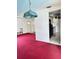 Spacious living room with red carpet and stained glass chandelier at 4363 Sansedro St, Port Charlotte, FL 33948