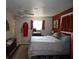 A spacious bedroom with orange walls, tile floor and a ceiling fan at 4363 Sansedro St, Port Charlotte, FL 33948