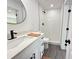 Remodeled bathroom featuring a walk-in shower, white cabinets, and a black faucet at 1100 Belkton Ave, Port Charlotte, FL 33948