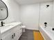 Stylish bathroom featuring white vanity, a bathtub, and black faucet and hardware at 1100 Belkton Ave, Port Charlotte, FL 33948
