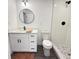 Renovated bathroom featuring white vanity, a walk-in shower, and black hardware at 1100 Belkton Ave, Port Charlotte, FL 33948