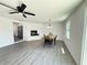 Dining room with fireplace, new floors, stainless steel refrigerator, and modern ceiling fan at 1100 Belkton Ave, Port Charlotte, FL 33948