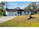 Charming single-story home featuring a well-manicured lawn and attached garage at 1100 Belkton Ave, Port Charlotte, FL 33948