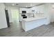 Updated kitchen featuring a breakfast bar, stainless appliances and hard surface counters at 1100 Belkton Ave, Port Charlotte, FL 33948