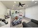 A modern living room adjacent to a bright white kitchen creates an inviting, open living space at 1100 Belkton Ave, Port Charlotte, FL 33948