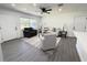 A living room adjacent to kitchen features a large window, recessed lighting, and hard surface flooring at 1100 Belkton Ave, Port Charlotte, FL 33948