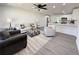A living room adjacent to kitchen boasts a ceiling fan, recessed lighting, and hard surface flooring at 1100 Belkton Ave, Port Charlotte, FL 33948