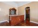 Wet bar with granite counters and custom woodworking next to temperature-controlled wine cellar at 17557 Ohara Dr, Port Charlotte, FL 33948