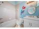 Cute bathroom with custom mural, single vanity, and tiled walls and floors at 17557 Ohara Dr, Port Charlotte, FL 33948