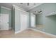 Spacious bedroom with large mirror, travertine floors, and walk in closet at 17557 Ohara Dr, Port Charlotte, FL 33948