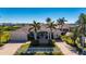 Stunning waterfront home featuring a tile roof, lush landscaping, and a paver driveway, perfect for luxurious living at 17557 Ohara Dr, Port Charlotte, FL 33948