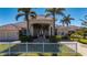 Inviting home with a grand entrance, well-manicured lawn, lush landscaping, and circular driveway with great curb appeal at 17557 Ohara Dr, Port Charlotte, FL 33948