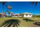 Expansive estate home with beautiful architecture, lush lawn, and swaying palm trees under a clear blue sky at 17557 Ohara Dr, Port Charlotte, FL 33948