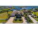 Beautiful home featuring lush landscaping, a brick driveway, and a tile roof, near the waterfront at 17557 Ohara Dr, Port Charlotte, FL 33948