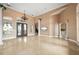 Elegant foyer featuring a high ceiling, a decorative chandelier, and arched doorways, providing a grand entrance at 17557 Ohara Dr, Port Charlotte, FL 33948