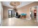 Inviting foyer with a decorative light fixture, tiled flooring, and comfortable seating, offering a warm welcome at 17557 Ohara Dr, Port Charlotte, FL 33948