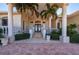 Elegant front porch with stately columns, decorative balustrades, and lush landscaping, inviting guests inside at 17557 Ohara Dr, Port Charlotte, FL 33948