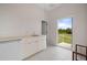Bright laundry room features a stainless steel sink, white cabinets, and outdoor access at 17557 Ohara Dr, Port Charlotte, FL 33948