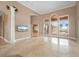 Spacious living room with large windows, a decorative column, and elegant tile flooring, perfect for entertaining at 17557 Ohara Dr, Port Charlotte, FL 33948