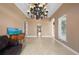 Bright living room with travertine flooring, arched doorways, and decorative chest at 17557 Ohara Dr, Port Charlotte, FL 33948