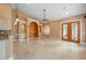 Spacious living room featuring custom built-ins, travertine floors, and arched doorways at 17557 Ohara Dr, Port Charlotte, FL 33948