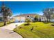 Charming single-story home with a three-car garage and a beautifully landscaped front yard at 24337 Contra Costa Ln, Punta Gorda, FL 33955