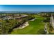 Scenic aerial view of a golf course and waterway, showcasing community living and recreational amenities at 3191 Village Ln, Port Charlotte, FL 33953