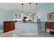 Cozy kitchen bar area with white cabinets, granite countertops, and pendant lighting at 3191 Village Ln, Port Charlotte, FL 33953