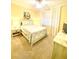 Cozy bedroom with bright walls, featuring a ceiling fan, window, and comfortable queen bed at 3311 Wood Thrush Dr # 111, Punta Gorda, FL 33950