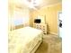 Comfortable bedroom with neutral walls, a ceiling fan, and a large window for natural light at 3311 Wood Thrush Dr # 111, Punta Gorda, FL 33950