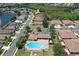 Aerial view of the community with a pool and clubhouse surrounded by lush landscaping and well-maintained homes at 5275 Layton Dr, Venice, FL 34293