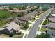 Aerial view showcasing the neighborhood's layout, lush greenery, and proximity to a serene lake with community amenities at 5275 Layton Dr, Venice, FL 34293
