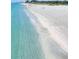 Stunning coastal view featuring crystal-clear water meeting the sandy shoreline at 5275 Layton Dr, Venice, FL 34293