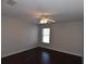 Bedroom with a ceiling fan, dark wood floors and a bright window at 5275 Layton Dr, Venice, FL 34293