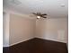 Comfortable bedroom featuring a ceiling fan and sleek, dark hardwood floors at 5275 Layton Dr, Venice, FL 34293