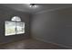 Bright bedroom with neutral walls, tile floors and large windows to maximize natural light at 5275 Layton Dr, Venice, FL 34293