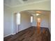 Comfortable bedroom features hardwood floors, a ceiling fan, and a doorway to an ensuite bathroom at 5275 Layton Dr, Venice, FL 34293