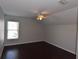Bedroom boasting sleek, dark hardwood floors and a brightly lit window at 5275 Layton Dr, Venice, FL 34293
