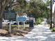 Centennial Park sign with walking path, park benches, and mature trees in the background at 5275 Layton Dr, Venice, FL 34293