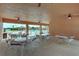 Outdoor community area with tables, chairs, and fans, offering a comfortable space for gatherings overlooking the pool at 5275 Layton Dr, Venice, FL 34293
