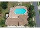 Aerial view of community pool with lounge chairs and a nearby parking area, perfect for relaxation at 5275 Layton Dr, Venice, FL 34293