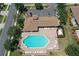 Aerial view of a pool with lounge chairs and lush landscaping, providing a relaxing retreat at 5275 Layton Dr, Venice, FL 34293