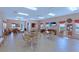 The community room features tables and chairs for residents to gather and socialize with a tv for entertainment at 5275 Layton Dr, Venice, FL 34293