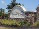 Stone community sign for Ventura Village with well maintained landscaping and pretty flowers at 5275 Layton Dr, Venice, FL 34293