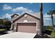 Side view of a two-story house with a well-maintained lawn and a two-car garage at 5275 Layton Dr, Venice, FL 34293