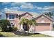Charming two-story home featuring a well-manicured lawn and a two-car garage at 5275 Layton Dr, Venice, FL 34293